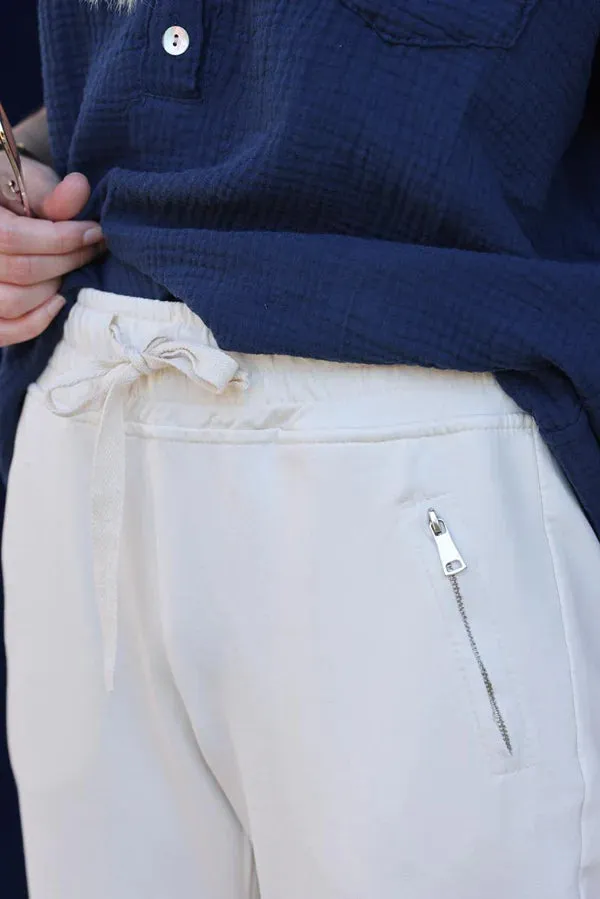 Jogging blanc cassé ceinture élastique poches zip